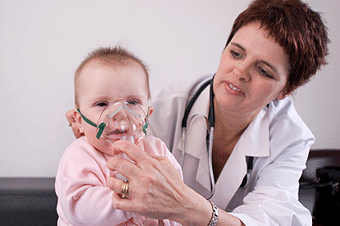 Doctor giving a child a breathing treatment